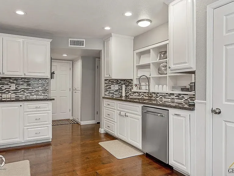 Kitchen leading to the garage door in the back. To the left of the garage door there's a half bathroom.