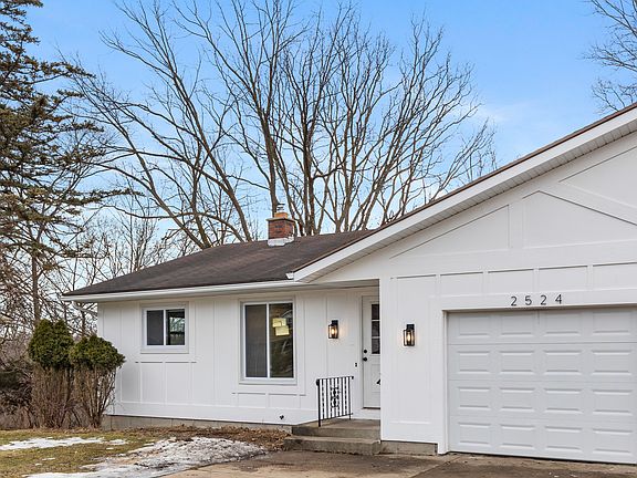 A horseshoe driveway offers 4 parking spaces for each unit, including the attached garage spot.