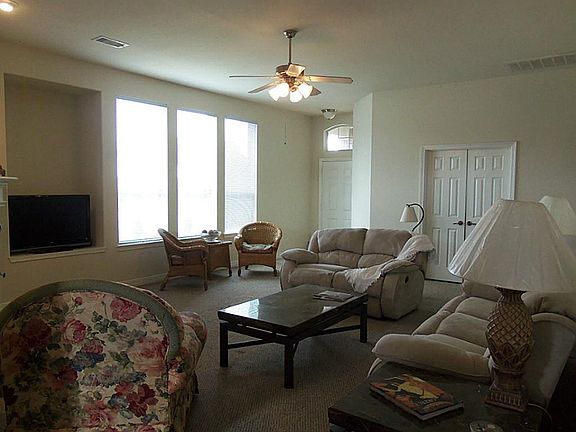 Living Room with Lots of Windows and French Door Entry into Master Bedroom