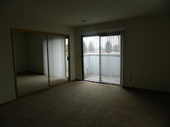 Large master bedroom with slider out to balcony.