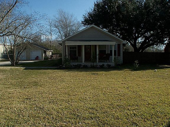 Large front yard  with a porch that sits back from the road