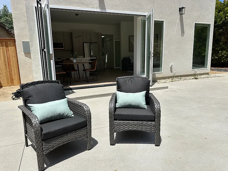 Outdoor patio with gas gill, dining table and chairs