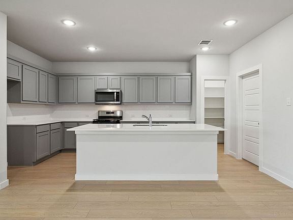 Kitchen in the Oscar home plan by Trophy Signature Homes - REPRESENTATIVE PHOTO