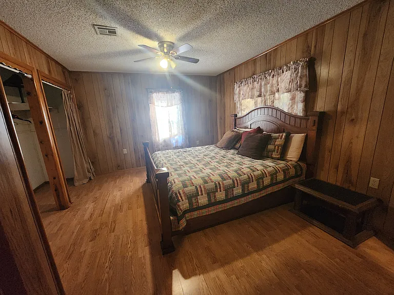 Bedroom #1 with king bed and ensuite bath. Large closet. Ceiling fan.