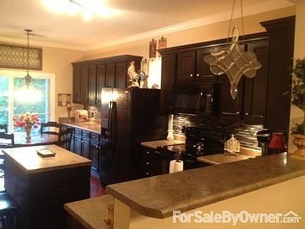 Tons of cabinets and storage
						:
						Gorgeous espresso cabinets, upgraded tile/stone backsplash, upgraded lighting
