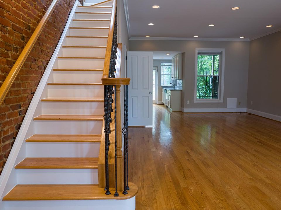 Open living and dining area with staircase leading to the second floor