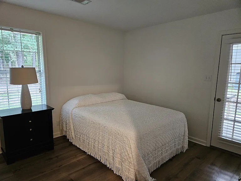 Back bedroom with Queen sized adjustable bed. Door to back porch. Large closet.