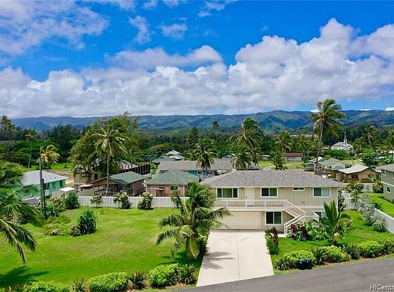 Spacious yard and beautiful home located adjacent to a 114 acre golf course and a mile long white sandy beach.