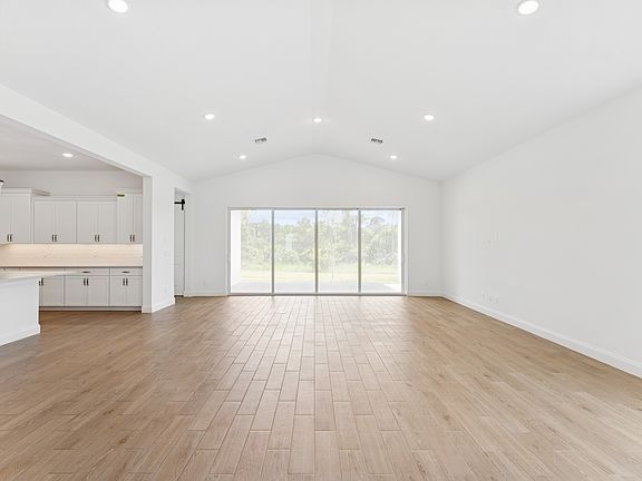 Open concept living spaces with vaulted ceiling
