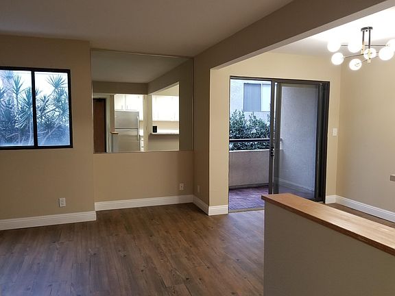 The living room with a sliding glass door to the balcony.