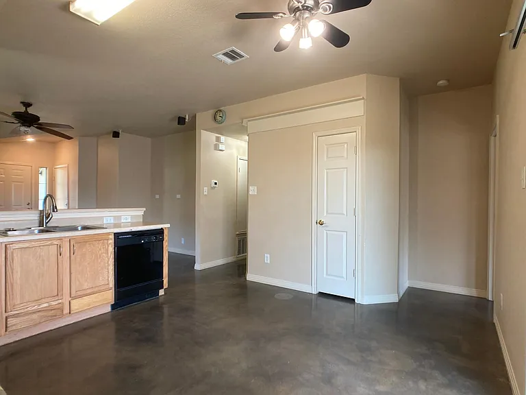 Kitchen/dining area. Hall on left to secondary bedroom. Hall on right to primary bedroom.