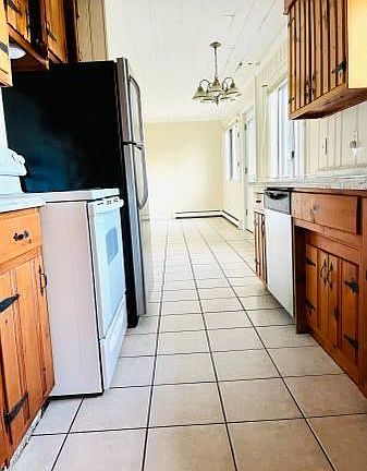 Kitchen with stainless refrigerator. Stove