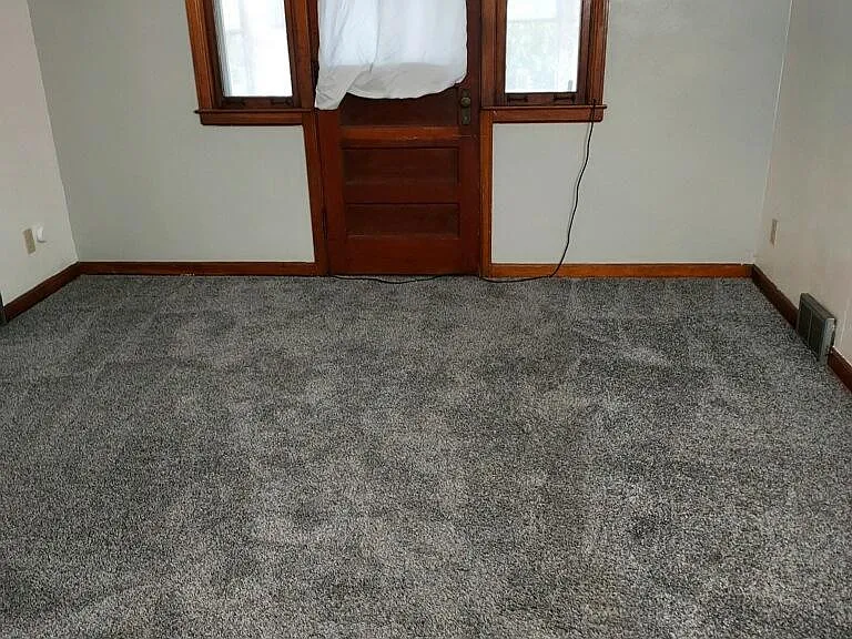 Living room showing door to screened in balcony.
