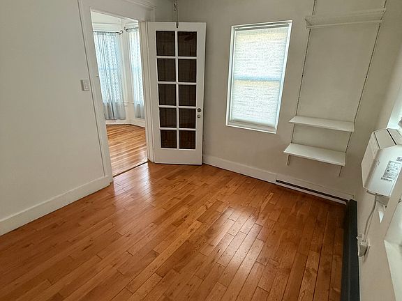 smaller bedroom with shelving
windows facing driveway and back yard