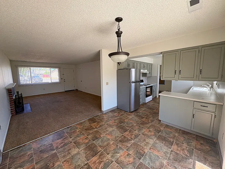 Dining area view to living room and kitchen