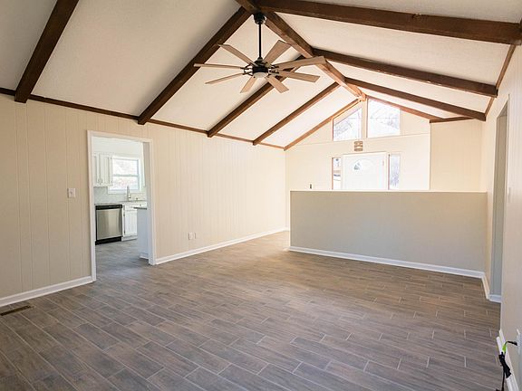 Beautiful living room with beams and ample sunlight