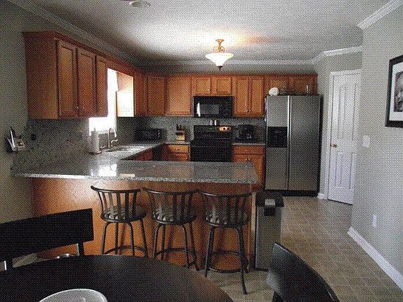 Kitchen with granite countertops, soft led undercabinet lighting, mosaic tile