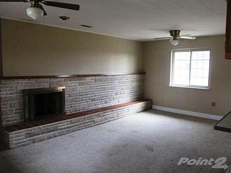 The family room is spacious and has a fireplace and a walk out to the backyard.