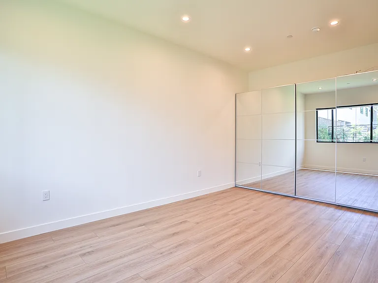 Bedroom with large mirrored closet