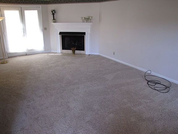 Large great room offers gas fireplace and doors leading out to deck