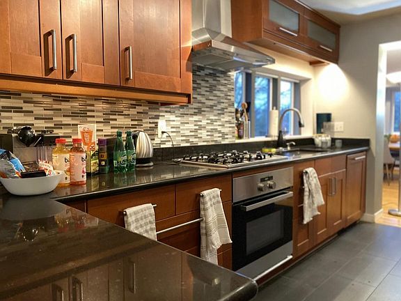 Large open kitchen with cherry cabinets, modern appliances, and lots of storage space