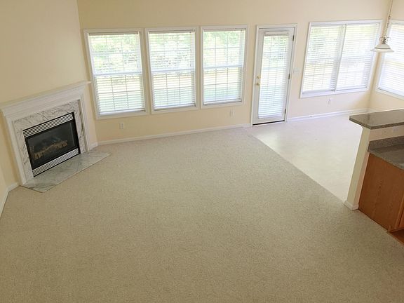 Family room with corner fire place. Breakfast room to the right. 8 windows provides plenty of light to brighten the area.