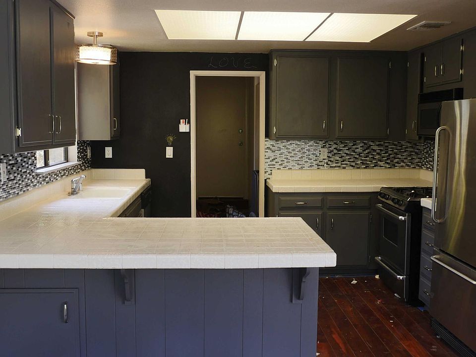 Remodeled Kitchen with Stainless Steel Appliances and Chalkboard Wall