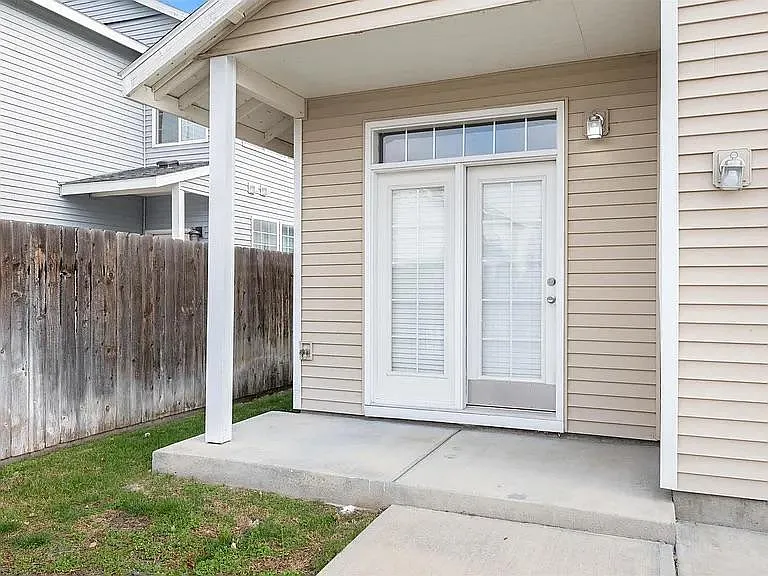 Back bedroom french doors and back patio area with yard