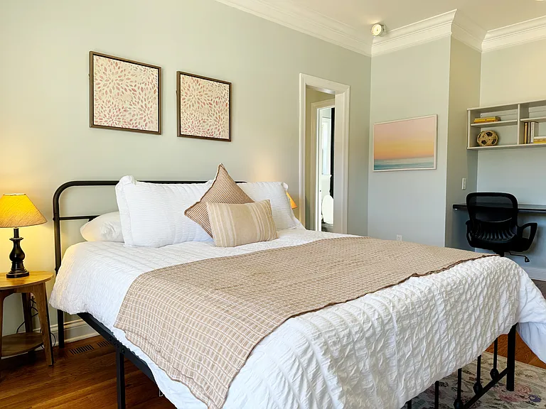 Another comfortable bedroom with an office space.