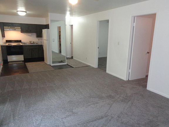 Living room with entry into bedrooms with fresh paint throughout interior.