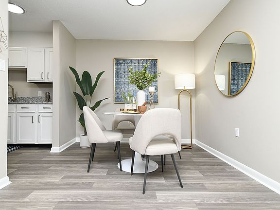 Dining area with hardwood-style flooring and overhead lighting