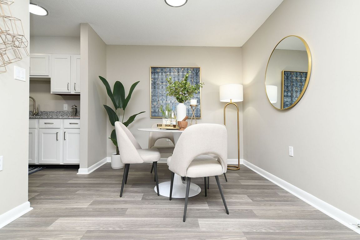 Dining area with hardwood-style flooring and overhead lighting