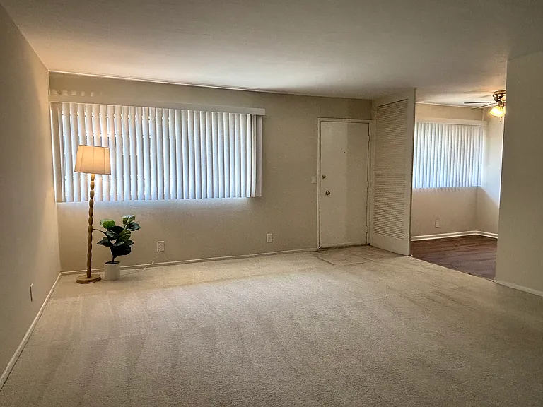 Unit 211B:
Bright and spacious living room and front door