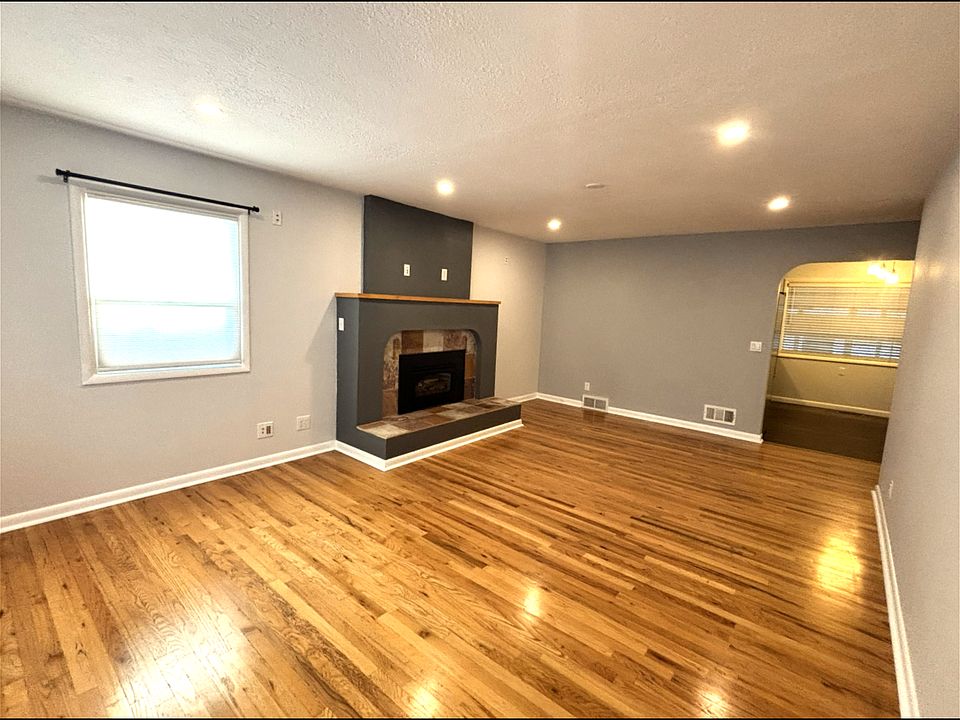 Living room, gas fireplace, and natural oak wood floors.