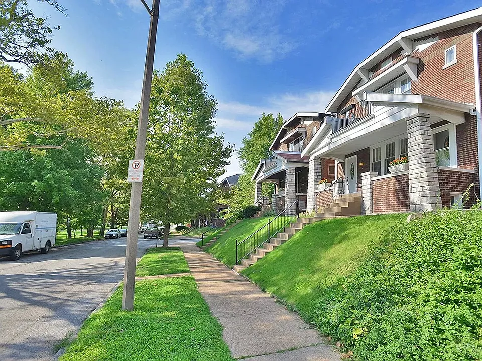 Front of building, well-kept & all-brick on a quiet tree-lined street w/ park views