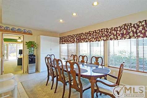 Adjacent to kitchen. This table sits 8 people. Some people have used this area as a family room