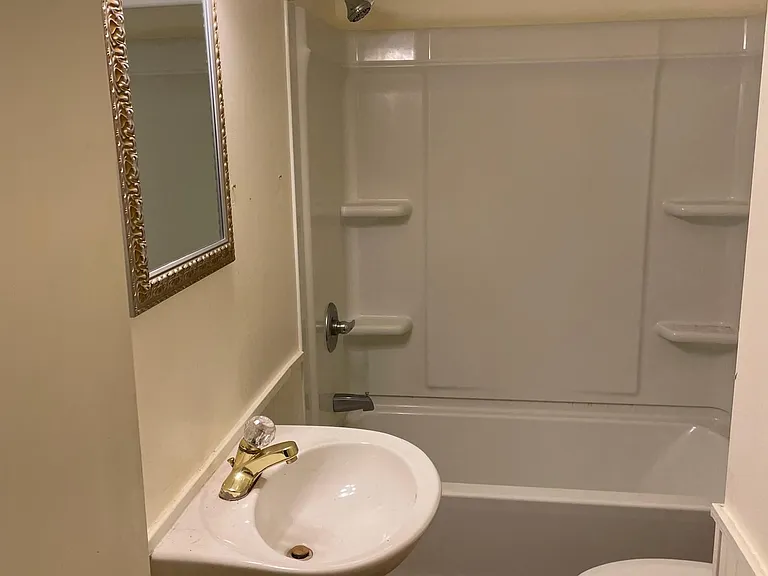 Remodeled Full bath and shower with tile floor and pedestal sink
