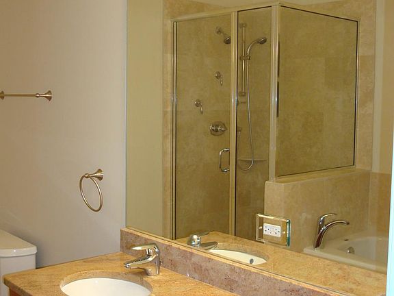 His & Hers sink in granite in spacious bathroom