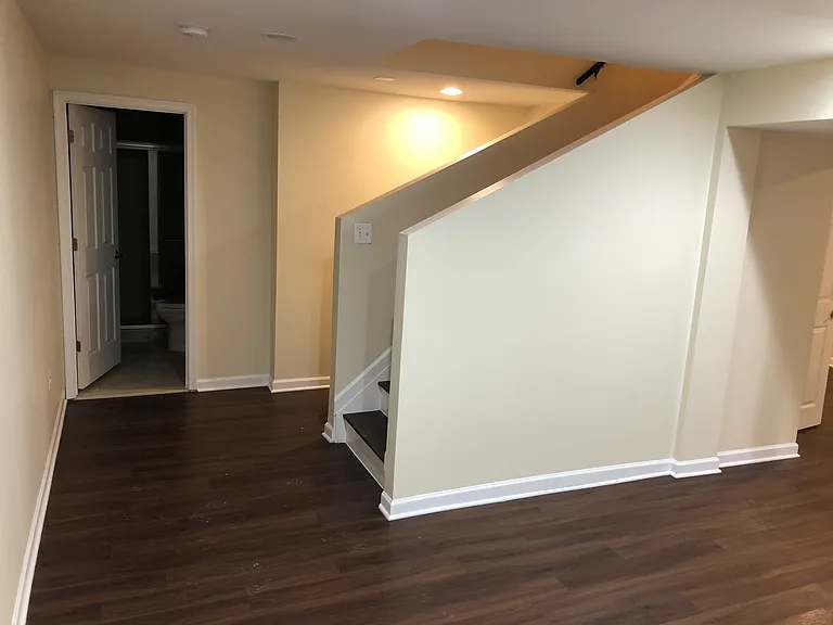Basement stairs and door to Basement Bathroom.