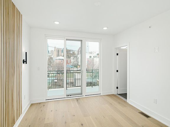 Main bedroom includes an accent wall and balcony.
