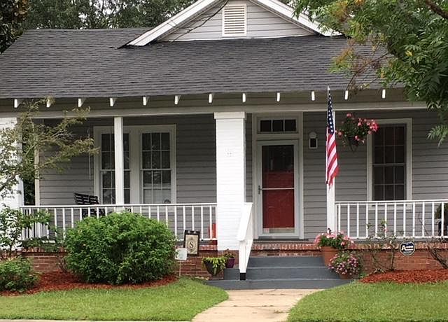 Home Exterior with porch swing and bannister