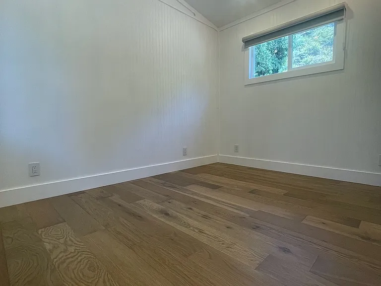 Bedroom fits a queen size bed with 2 small night stands.