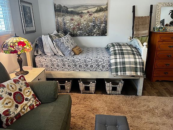 Under bed storage with a ladder filled with towels and extra linens for your use.