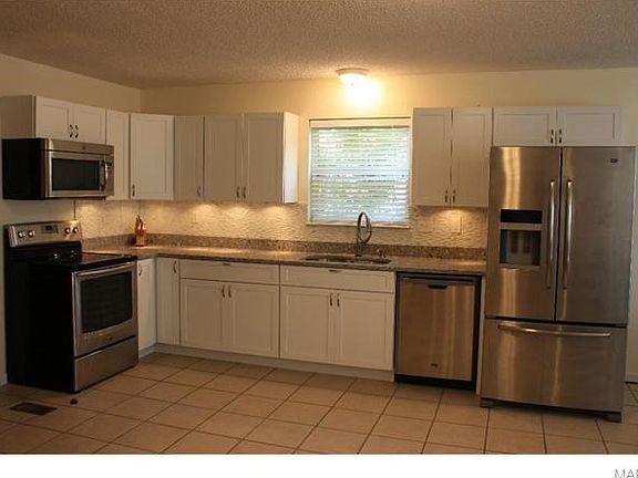 Gorgeous Kitchen updated in 2012 with Thomasville Cabinets w/under cabinet lighting, Quartz counter top, Maytag stainless steel appliances and "Touch" faucet and tile floor.