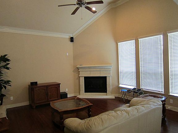 Wood floors in den with fireplace off breakfast are