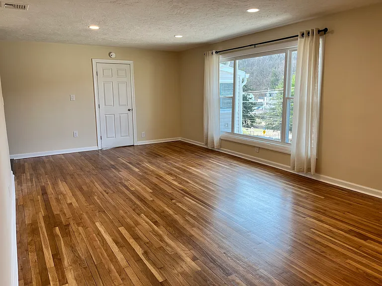 Living room facing door to master bedroom suite