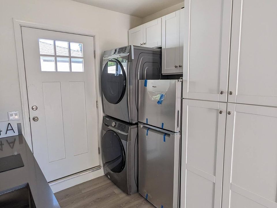 kitchen area with washer/dryer, pantry and refrigerator