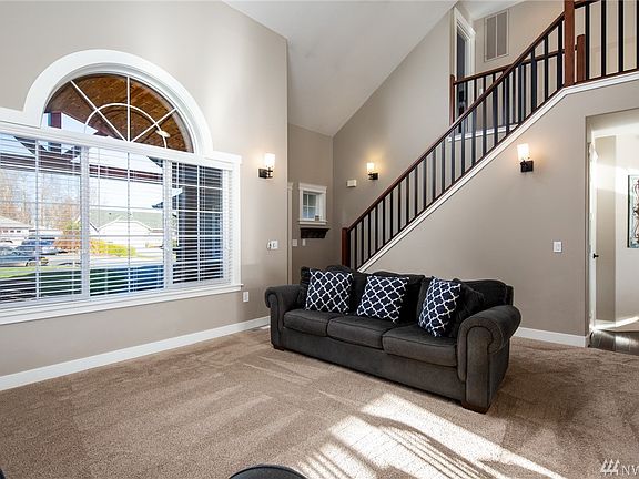 As you enter the home you are greeted with soaring ceilings and a large formal living room.