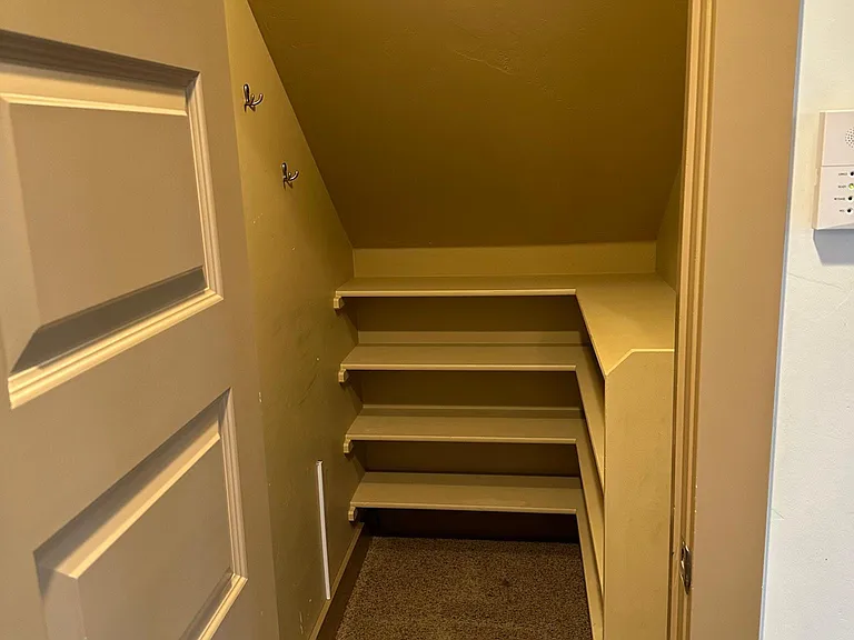 Storage closet just inside door from garage (located under stairs)