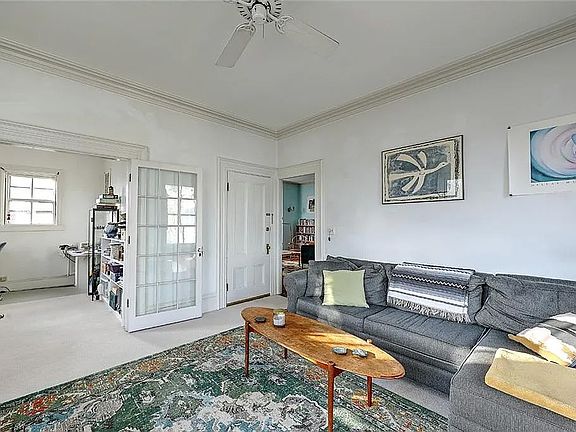 Main living room, furnished, before repainting, and with the old carpet that has been replaced for LVP wood floors